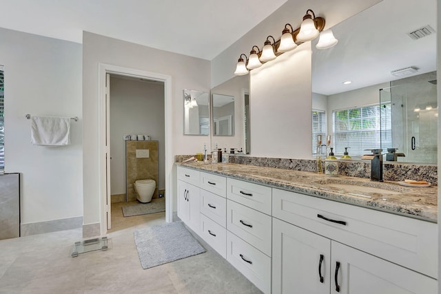 bathroom featuring tile patterned flooring, toilet, and dual bowl vanity