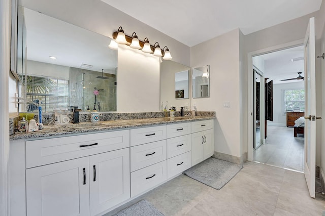 bathroom featuring a shower with shower door, dual vanity, tile patterned floors, and ceiling fan