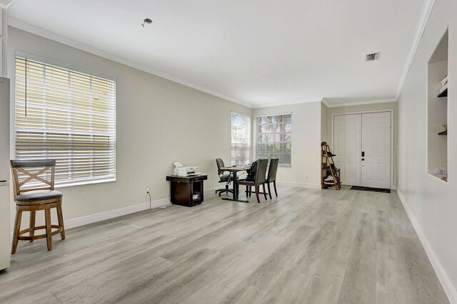 office featuring ornamental molding and light hardwood / wood-style flooring