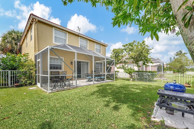 back of house with a yard, glass enclosure, and a patio area