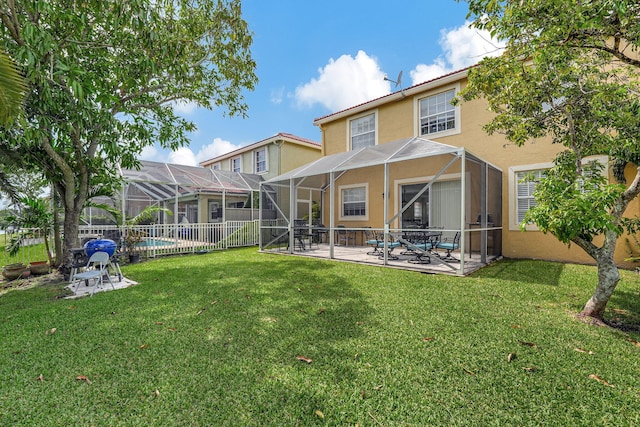 rear view of property with a lanai, a patio, and a yard