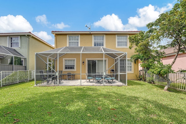 back of property with a patio, a lanai, and a yard