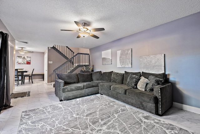 tiled living room featuring a textured ceiling and ceiling fan