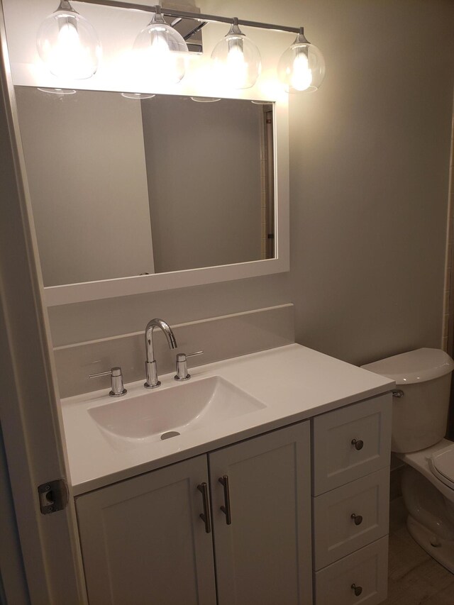 bathroom featuring vanity and toilet