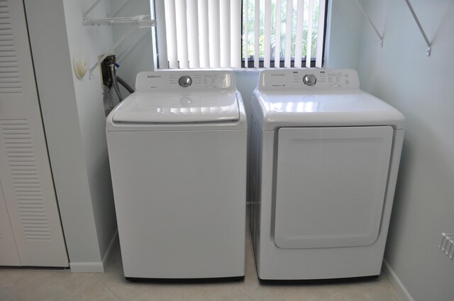 laundry room with light tile patterned floors and washer and dryer