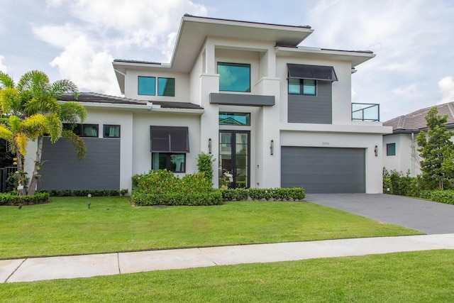 view of front facade with a garage and a front lawn