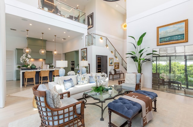 living room featuring light hardwood / wood-style floors and a high ceiling