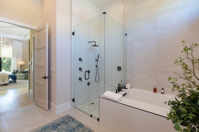 bathroom with plus walk in shower and tile patterned flooring