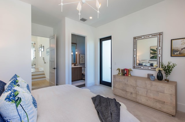 bedroom with ensuite bathroom, ceiling fan with notable chandelier, and light colored carpet