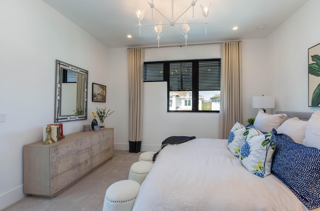 carpeted bedroom featuring an inviting chandelier