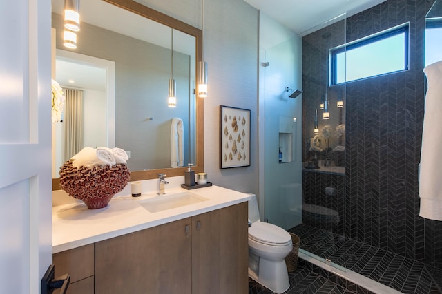 bathroom featuring tile patterned floors, toilet, vanity, and an enclosed shower