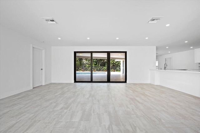 unfurnished living room with light hardwood / wood-style floors