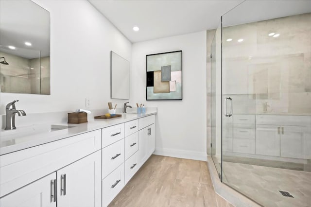 bathroom featuring vanity and a shower with door