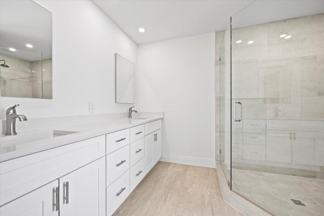 bathroom featuring a shower with door, vanity, and hardwood / wood-style flooring