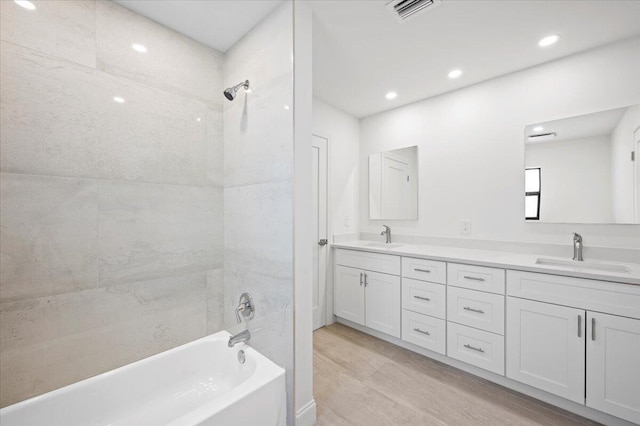 bathroom featuring vanity and tiled shower / bath combo