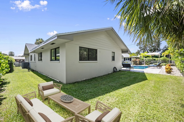 back of property with a lawn and a fenced in pool