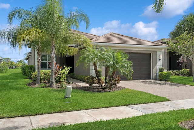 view of front of home with a garage and a front yard