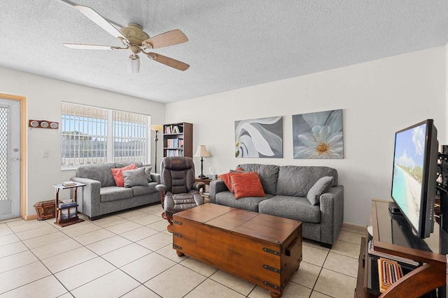 tiled living room featuring a textured ceiling and ceiling fan