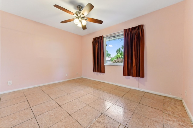 tiled spare room with ceiling fan