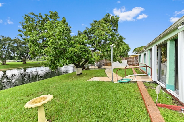 view of yard with a water view and a patio area