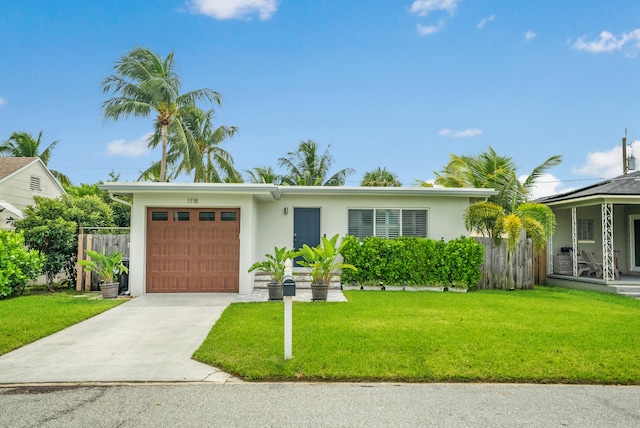 view of front of property with a garage and a front yard