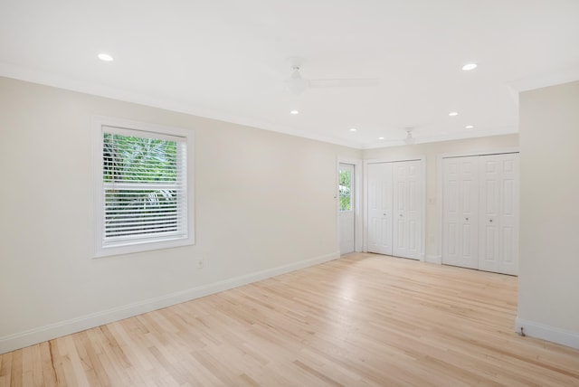 unfurnished room featuring ornamental molding, light hardwood / wood-style flooring, and a wealth of natural light