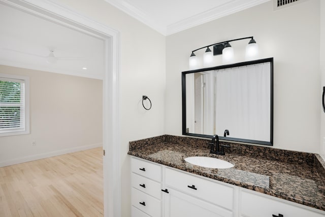 bathroom featuring vanity, crown molding, ceiling fan, and wood-type flooring