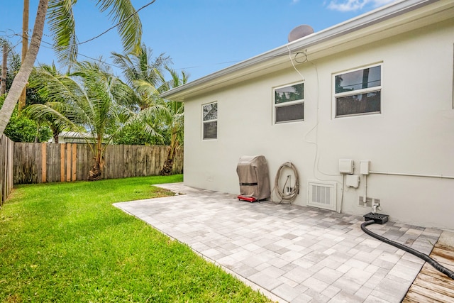 exterior space with a patio and a lawn