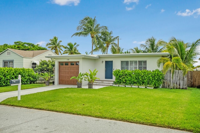 ranch-style home featuring a garage and a front yard