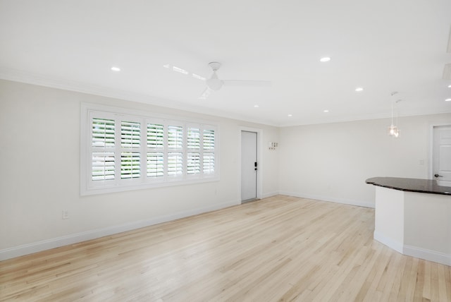 unfurnished living room with light hardwood / wood-style flooring, ceiling fan, and crown molding