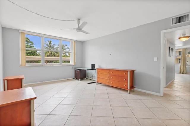 interior space with light tile patterned floors and ceiling fan