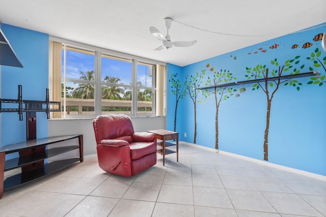 living area featuring tile patterned flooring and ceiling fan