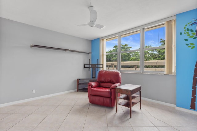 living area with ceiling fan and light tile patterned floors