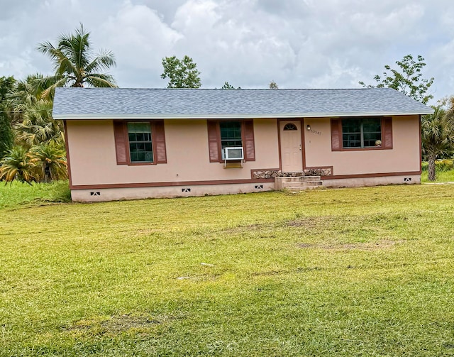 view of front of house featuring cooling unit and a front lawn