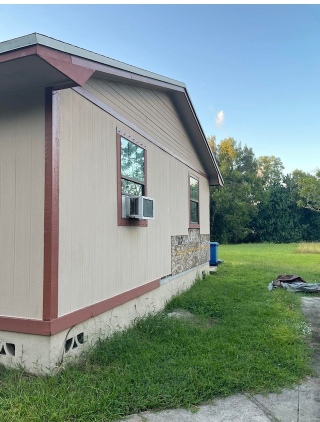 view of side of property with a lawn