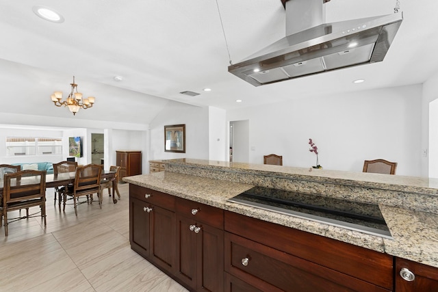 kitchen featuring range hood, light stone countertops, a notable chandelier, light tile patterned floors, and black electric cooktop