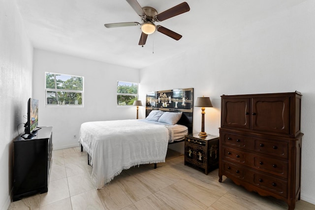 bedroom with ceiling fan and light tile patterned flooring