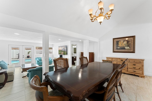 tiled dining space featuring lofted ceiling, french doors, a chandelier, and a healthy amount of sunlight