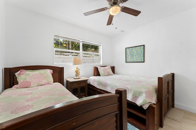 tiled bedroom featuring ceiling fan