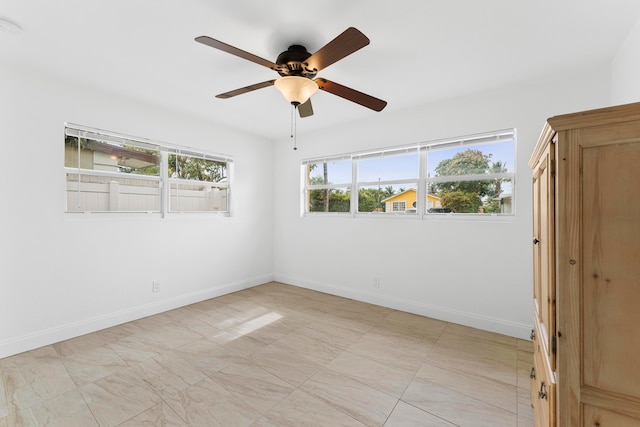 unfurnished room featuring ceiling fan and light tile patterned floors