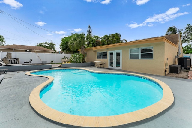 view of pool featuring french doors and a patio