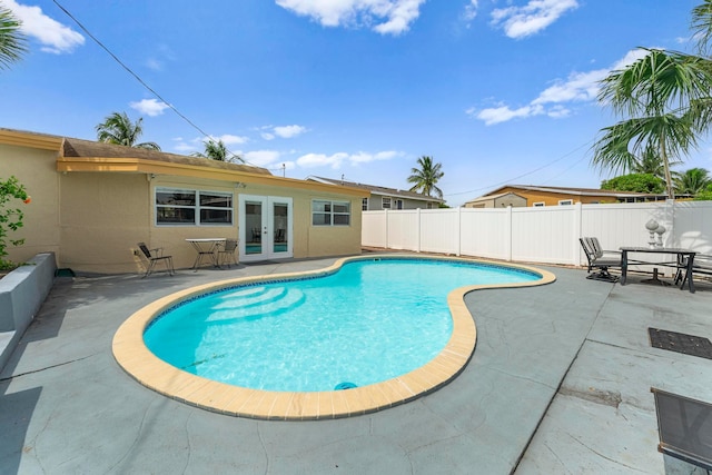 view of pool with a patio and french doors