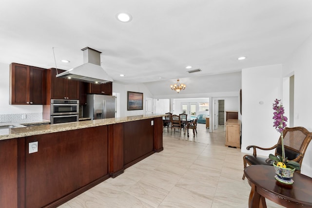 kitchen with a chandelier, island exhaust hood, light stone countertops, light tile patterned floors, and stainless steel appliances