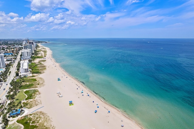 bird's eye view featuring a water view and a beach view