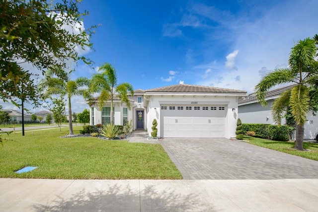 mediterranean / spanish house with a front lawn and a garage