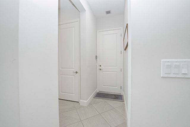 hallway featuring light tile patterned floors