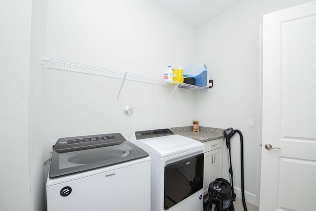 laundry room with cabinets and separate washer and dryer