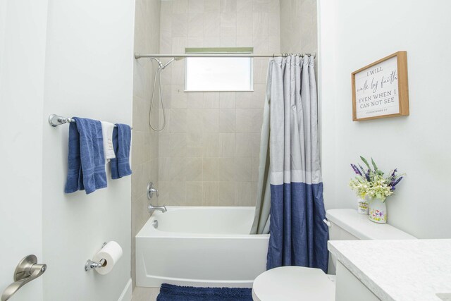 full bathroom with shower / bath combo with shower curtain, vanity, and toilet