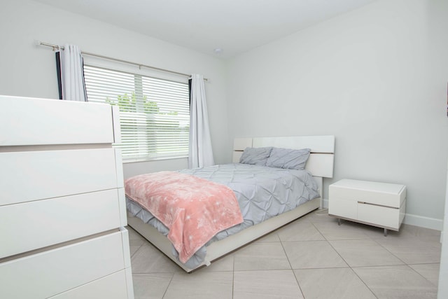 bedroom with light tile patterned floors