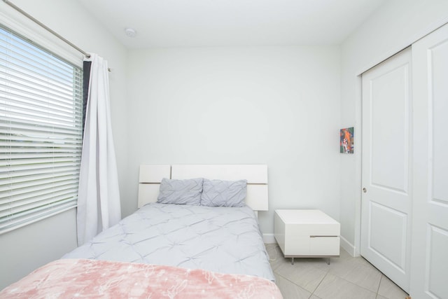 tiled bedroom with a closet